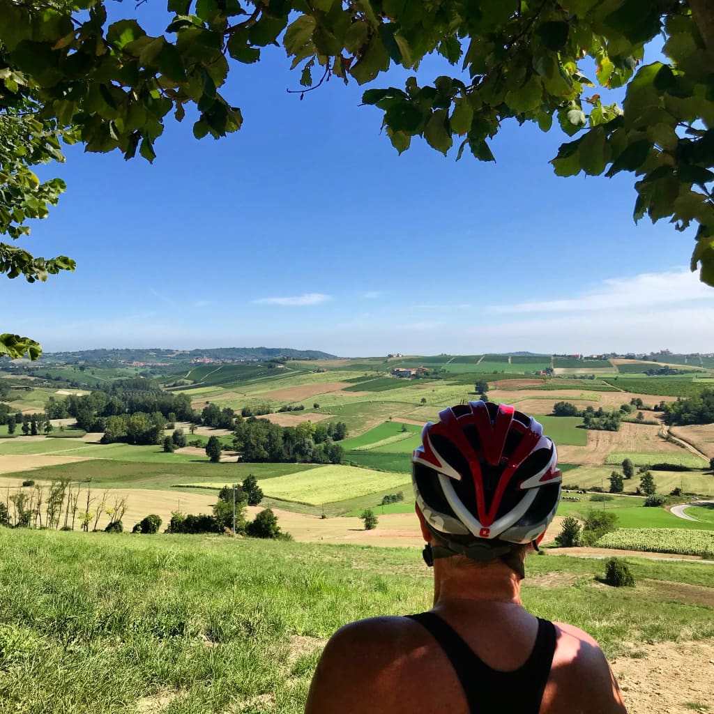 Cyclist overlooking the rolling hills of the Langhe, Piedmont